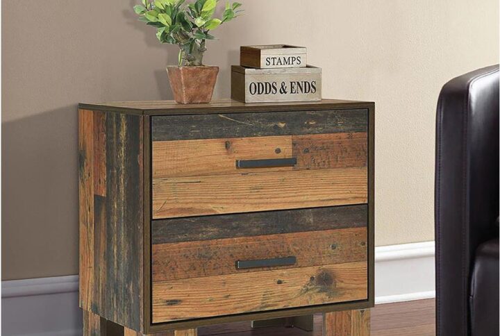 Revel in the nature-inspired flavor of a piece that defines a contemporary space with an abundance of earthy elegance. Notable gradations stand out in the rustic pine finish of this two-drawer nightstand. Strive for a cabin motif in this contemporary nightstand with dark bronze matte metal hardware and linear styling. Finished drawer boxes with front and rear English dovetail construction and center drawer glides ensure smooth operation