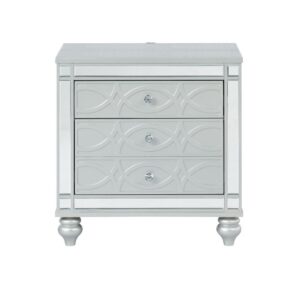 Bring modern glam to a classic design with this transitional two-drawer nightstand. It features a glitzy design that draws the eye in any modern home. It's crafted with a vibrant silver metallic finish with fret work detail on the front panels and drawer fronts. The drawers are adorned with crystal-like pulls and the top one is lined with black felt. Dual USB ports and delicate bun feet complete the design of this exquisite accent piece.