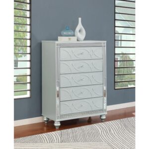 Enhance your home with a modern glam update to a classic design with this transitional five-drawer chest. It boasts a dazzling design that takes lends glitz to any modern bedroom. It comes in a vibrant silver metallic finish with fret work detail on the front panels and drawer fronts. The drawers are adorned with crystal-like pulls and the top ones are lined with black felt to protect treasured valuables. Delicate bun feet complete the design of this exquisite masterpiece.