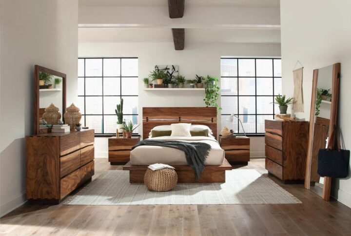 This four-piece bedroom set has a sturdy stance and unique style that fits any master bedroom. Each piece has a beautiful smokey walnut finish with wood grain accents. The eastern king bed is fashioned on a platform style design with a distinctive two-piece headboard with a full-length opening. The nightstand and dresser are conveniently built with deep