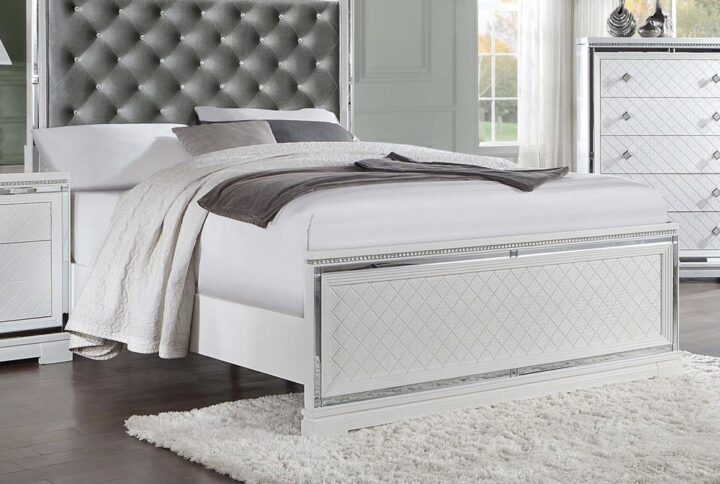 Vibrating radiance and elegance is this glamorous bed from the Eleanor bedroom collection. With stunning features like reflective mirror trim accents and a button-tufted padded headboard with sparkling crystal-like buttons set in a silver velvet fabric