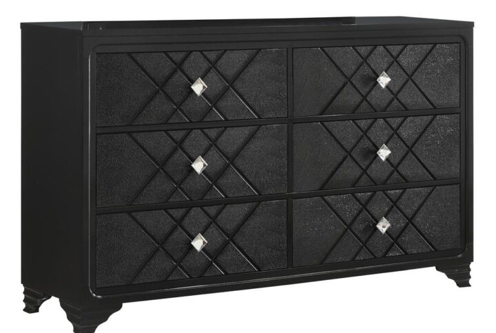 Glitz and glam will overtake your sleeping space with this incredible black dresser. Six drawers display embossed panels with a geometric pattern. The diamond-style acrylic hardware makes for an incredible and elegant upgrade for this contemporary piece. A spacious tabletop brings plenty of space to display decorative items and bedside essentials. Enjoy years of durability and beauty from this piece
