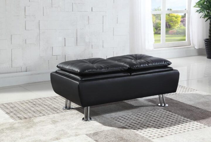 This versatile ottoman is an ideal complement to the Dilleston sofa bed. It's wrapped in matte black leatherette that's refined and sophisticated. Cushioned top is comfortable for putting your feet up or using as a short stool. Ottoman also opens to reveal spacious storage for hiding the remote when watching the big game or your favorite show uninterrupted. Also comes in white