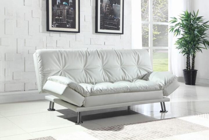 The Dilleston collection features this white sofa bed with dashing appeal. With deluxe pillow-top seating and adjustable armrests