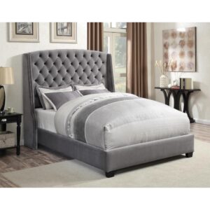 the bed is crafted in a charming wingback design. It's upholstered in velvet with a luxurious button-tufted headboard that features meticulous individual nailhead trim. Solid wood-turned legs are finished in rich contrasting cappuccino. This bed is an elegant centerpiece for the bedroom.