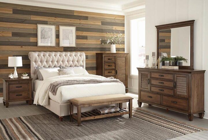 This delightful bed adds stylish elegance to the bedroom. The headboard is constructed with a handsome rolled design. The majestic headboard is also upholstered in luxuriant fabric with a button-tufted pattern with gorgeous individual nailhead trim. The solid wood-turned legs come in a warm cappuccino finish. This bed adds an element of grace and sophistication to the bedroom.