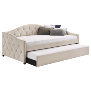 this daybed and trundle combo lends traditional elements such as a button-tufted back and sides. Thin sloped sides and a camelback offer a graceful design and feminine charm to compact rooms where additional sleeping arrangements come in handy. Tucked beneath the main frame is a hidden trundle set