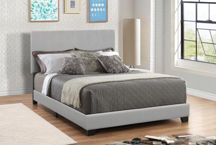 Create a sophisticated visual with the sleek lines from this leatherette upholstered bed frame. Neutral hues feature stitched details along the center