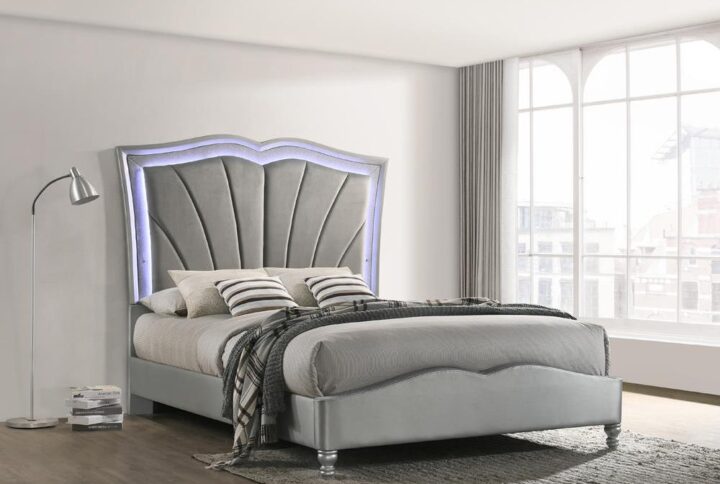 Lend an ultra-glamorous touch to your bedroom with this upholstered bed. This bed features a striking headboard in a flared fishtail design