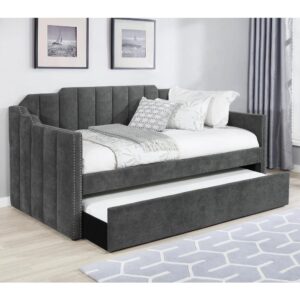 Welcome guests to stay for the night with this contemporary twin daybed and trundle set. Wrapped entirely in a charcoal gray velvet fabric with an Art Deco-inspired channel tufted design and stepped edges