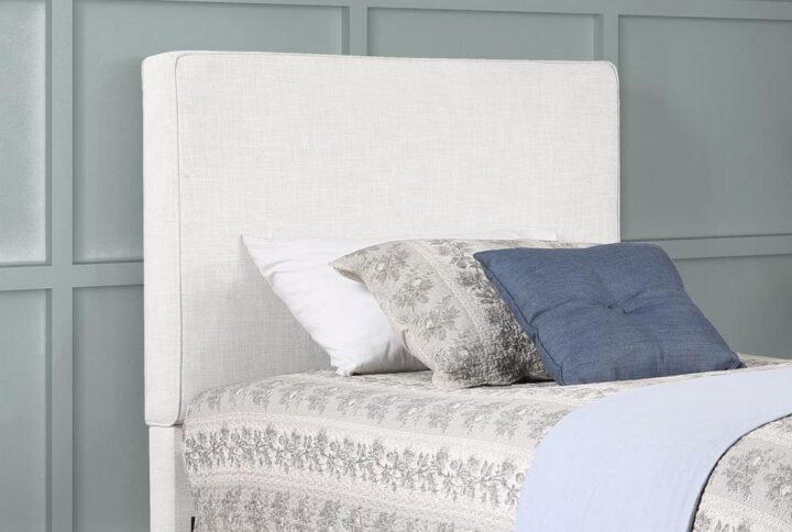 The exemplary and simple style of this classic headboard offers a perfect update to any bed. This upholstered headboard blends clean lines and dimensional upgrades to transform a bedroom into a haven for relaxation. Self-welt construction details add a sleek look to the outer border. Textured sand finish fabric wraps over the headboard