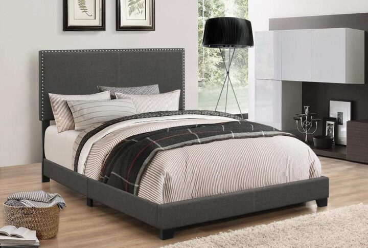 Embrace a relaxed modern style with the smooth edges from this upholstered bed frame. Complete with solid wood legs in black finish