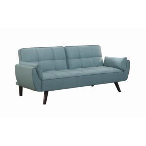 woven fabric in a stunning shade of turquoise blue. A biscuit-tufted seat and back give it a touch of updated glamour. With a soft