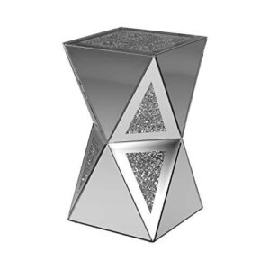 Revel in the eccentric style that is contemporary glam with this side table. Geometric design and unique shape make this a conversation piece. Celebrate the modern style with the architectural appeal. Elegant silver finish presents opportunities for matching with other pieces. Bring this eccentric side table home to stimulate discussion.