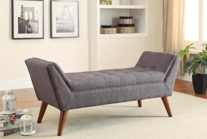 This handsome retro style bench helps give a family room or living room personality. Upholstered in grey linen-like fabric