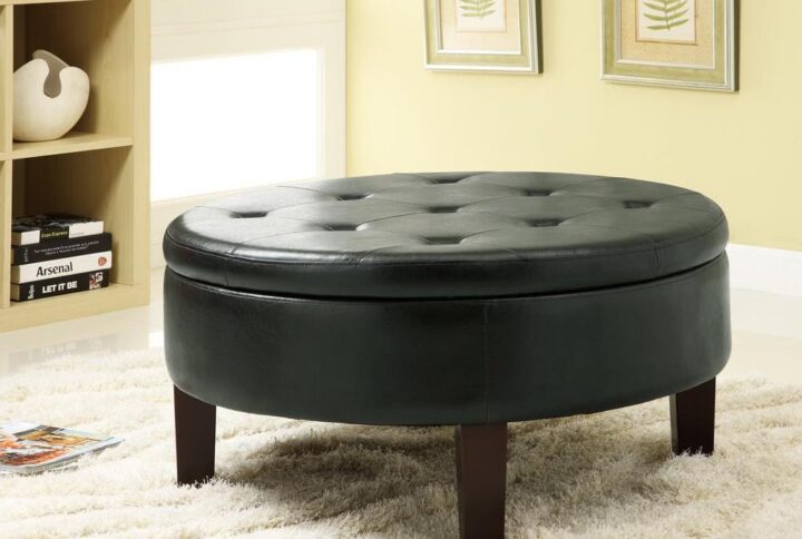 A surprisingly decorative round shape sets this ottoman apart from linear designs. Rich dark brown leatherette delivers a sleek