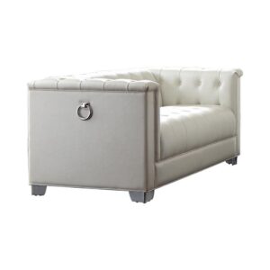 stylish loveseat has a delightfully contemporary look. Heavy-duty chrome doorknocker handle accents give it an intriguing touch of artistry. Deep button tufting pulls its design together with fashionable flair. Upholstered in padded