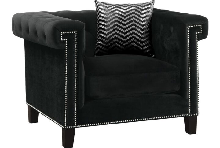 Character on parade. Capture deserved attention with this exceptional black armchair. Fun design elements include a high profile tuxedo silhouette that spans traditional with modern. A kiln dried hardwood encased frame builds a solid platform softened with feather blend seat cushions. Throw tufting and nail heads into the mix
