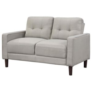 this loveseat boasts a perfect small-scale design. Its classic track arm and self-welt detailing highlight the superior tailoring. The grid-tufted boxed back cushions and pocket coil spring cushion construction ensure comfort and support. With brown tall round tapered legs