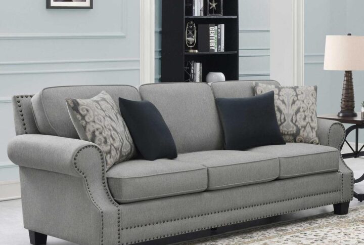 Covered in a chic gray upholstery and glammed up with an enticing silhouette