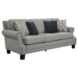 this stylish sofa bridges modern and farmhouse to create versatile transitional fare. This lush sofa is dressed up with ornate features such as rolled arms with recessed sculpted arm panels trimmed in self-welt and individual hand-driven antique nail heads. Supportive cushions set up a relaxing