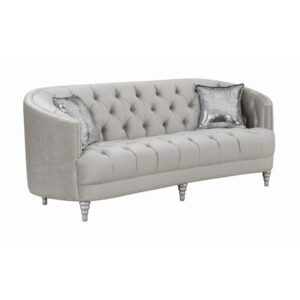 This stationary sofa is as stylish as it is functional. It features an appealing button-tufted design that imparts elegance. Seat back leads to a wraparound armrest that surrounds you in comfort. Extra thick cushions ensure hours of relaxed contentment. It comes wrapped in opulent grey material that will steal the show in your living room.