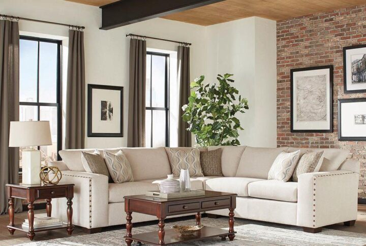 This showpiece sectional sofa is the perfect highlight for a living room or sitting room. Thick cushions wrap you in hours of elegant comfort whether enjoying afternoon tea or an after-dinner conversation. The nailhead design on the armrests conveys a distinctive style. Wide armrests and tapered legs impart a sturdy promise of durability and reliability. Light-colored material gives this impressive sectional a lighter presence.