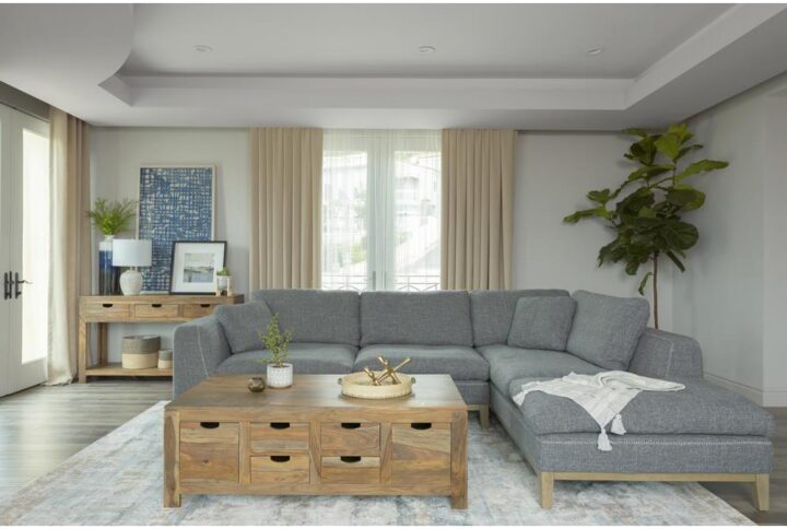 Add style to your space with this magnificent Mid-Century Modern sectional sofa. This low profile 2-piece sectional is exceptionally upholstered in a textured cool grey woven fabric accented with contrast blanket stitching in beige. Equally appealing is the beige platform base with tall tapered legs. On one end