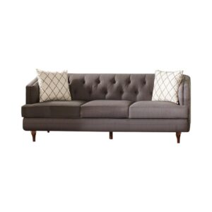 Give a new look to your living room with this transitional sofa from the Shelby collection. This grey upholstered sofa features a barrel style back with angled arms for a sophisticated look. Button tufting inside the back and arms offer charming upholstery details. Tapered turned legs are crafted of pine with a rich brown finish. Two accent pillows in a sleek print are included to complete this look.