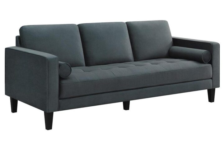 Wrapped in a bold dark teal velvet upholstery that adds a touch of glam