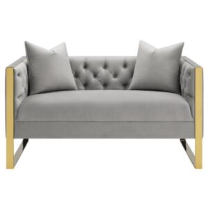 but it's the cozy comfort that will leave you hooked. The button tufted velvet upholstery comes in an elegant light grey finish that's soft to the touch. Two throw pillows are included for your next restful lull. Then there's the gold stainless steel base that wraps around the arms and forms U-shaped legs. The mix of gold and grey with the blend of metal and soft fabric makes this loveseat a feast for the senses.