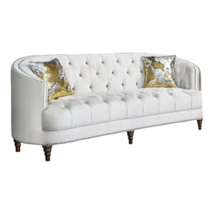 Transform your living space with a modern spin on a classic sofa. This transitional style sofa features an innovative C-shape design that's both comfortable and graceful. The soft velvet upholstery radiates in a chic champagne finish and features the glam of deep rhinestone button tufting. Lustrous chrome nailhead trim adds an elegant accent that's subtle yet effective. This majestic design is topped off by exquisitely turned legs and two included complementary accent pillows for a sofa as stylish as it is practical.