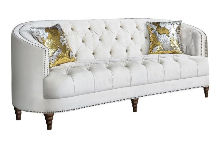Transform your living space with a modern spin on a classic sofa. This transitional style sofa features an innovative C-shape design that's both comfortable and graceful. The soft velvet upholstery radiates in a chic champagne finish and features the glam of deep rhinestone button tufting. Lustrous chrome nailhead trim adds an elegant accent that's subtle yet effective. This majestic design is topped off by exquisitely turned legs and two included complementary accent pillows for a sofa as stylish as it is practical.