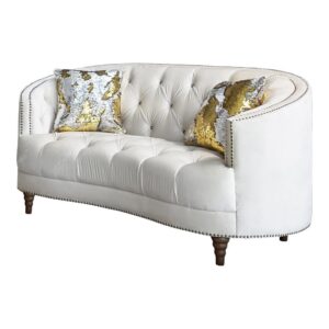 This modern spin on a classic loveseat will transform your living space. It features a cozy C-shape design that's innovative and graceful. The soft champagne velvet upholstery radiates with a chic energy and features the glam of deep rhinestone button tufting. Chrome nailhead trim throughout adds a subtle elegance that can't be ignored. Exquisitely turned legs and included complementary accent pillows complete the design of this magnificent loveseat.