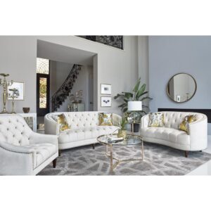 This modern spin on a classic loveseat will transform your living space. It features a cozy C-shape design that's innovative and graceful. The soft champagne velvet upholstery radiates with a chic energy and features the glam of deep rhinestone button tufting. Chrome nailhead trim throughout adds a subtle elegance that can't be ignored. Exquisitely turned legs and included complementary accent pillows complete the design of this magnificent loveseat.