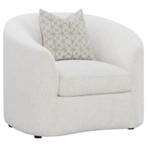 upholstered in a neutral latte finished boucle fabric throughout its contoured silhouette and curved sloped armrests. Accented by a single throw pillow