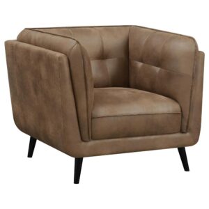 designed in an updated Chesterfield style complete with plush grid tufted seats and cushions upholstered in a soft and smooth brown microfiber leather. Lending a bold vintage flair are tall