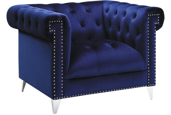 A bold blue armchair brings admiration from all guests. Enticingly soft velvet fabric is brought to life with a button tufted backrest. Extra wide seating provides a plush and comfortable place for reading or relaxing. Nail head trim and tuxedo arms enhance the aesthetics of your new armchair. This piece is supported on tapered chrome legs.