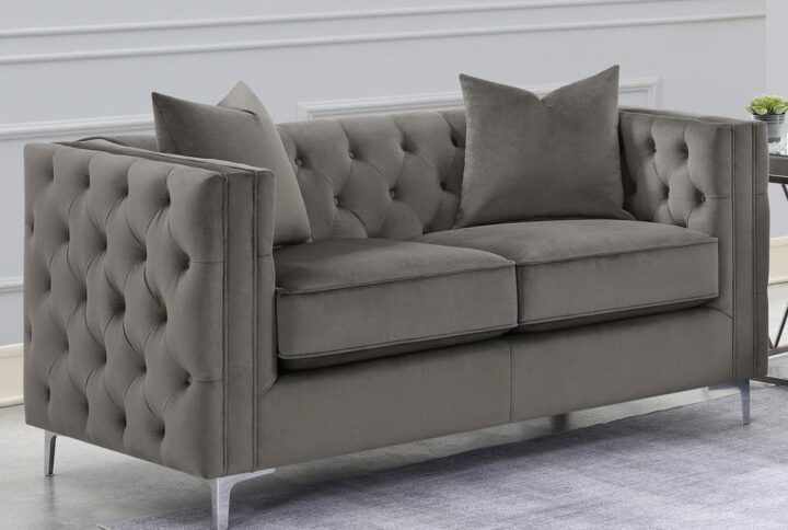 Create a mid-century modern flair to your living room with this modern glam loveseat. Designed in a tuxedo-inspired frame upholstered in a soft urban bronze velvet