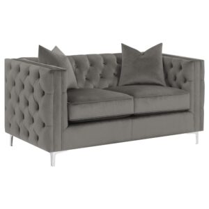 this loveseat presents the perfect place to rest after a long day. The taught button-tufted backrest and wide track arms offer a seamless and flush silhouette that embraces you comfortably. Supportive metal bracket legs in a cool tone metallic finish lend a chic ultra-modern expression. Two matching dark tone throw pillows soften the corners and add a final touch.