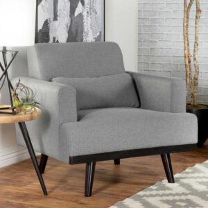 Modern rooms keep it simple and stylish with a hint of mid-century modern design at play. This accent chair offers a versatile sharkskin finish fabric upholstery that blends with a variety of design palettes. Embrace the iconic rolled arms and fixed T-cushion silhouetting of a chair with dark brown tapered legs. A fixed