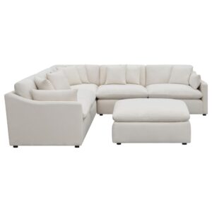 featuring a soft and textural ivory fabric. Tailored seats embellished with reversible cushions