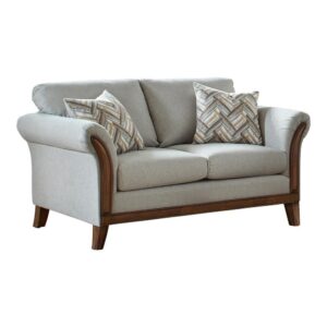 this transitional loveseat lends itself to a variety of color palettes. Contrasting hues in a brushed brown wood trim offer an earthy