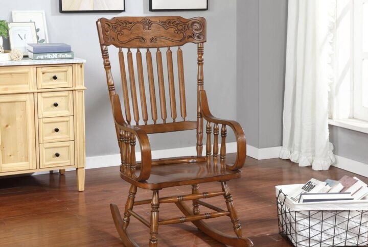 Attention to detail creates a stylish choice for seating. This elegant rocking chair shows off a host of traditional design elements. An ornamental headrest pattern offers artistic beauty in a chair with a contoured silhouette. Lush warm brown delivers a versatile and gorgeous finish. Enjoy a relaxing rocking experience in a living space or nursery.