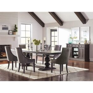 the table is designed with a spacious rectangular tabletop and a double pedestal base with exquisitely curved accents. Upholstered dining chairs are available in a versatile grey color