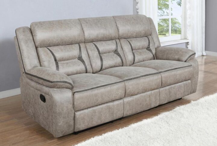 A motion sofa with a drop down center will serve you well in your entertainment space. Leatherette upholstery is enhanced with stitching details that make an impact in the craftsmanship. Pocket coil cushioning keeps you comfortable and cozy for hours of enjoyment. A pop-up power outlet with a USB charger allows you to keep devices charged and on hand. With stainless steel cupholders