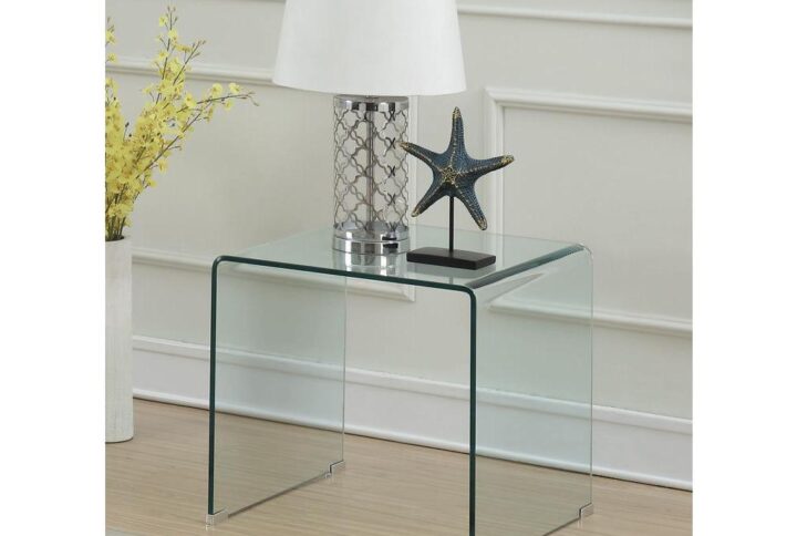 This splendid end table has a contemporary design that's also enduring. This single-piece table features a clear glass-like material that adds a unique look to the home. Square table top is roomy enough for a decorative modern lamp and a handsome vase or small sculpture. It has an open space design instead of a base so you can put a small potted plant directly on the floor beneath the table top. Can be put beside a contemporary sofa or against a wall as a standalone piece.
