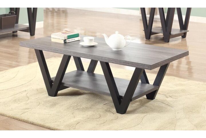This endearing coffee table has a mid-century modern design that's suitable for any home. The grey rectangular table top is perfect for a vase and candles or even a laptop and tablet. A shelf below is ideal for holding a small fern or decorative basket. The four black finished legs come in a prominent V-shaped design that lends an extra flair to the table. It's got a versatile design and color pattern that matches well with any decor.