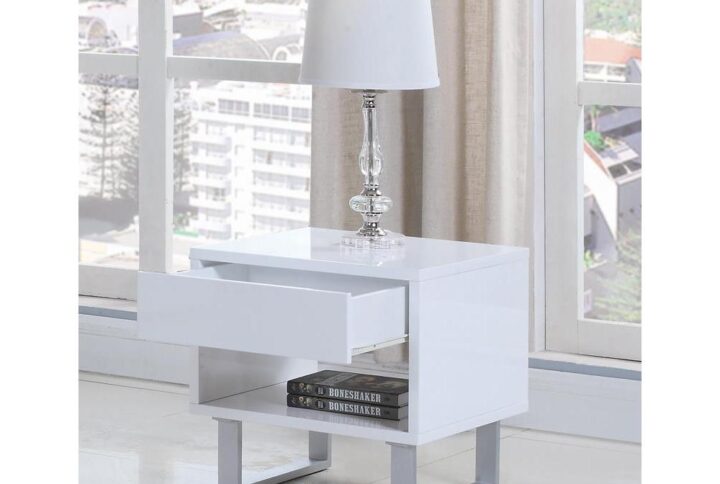 Create a crisp visual in any living room or bedroom with the open lines from this white end table. In a high glossy finish