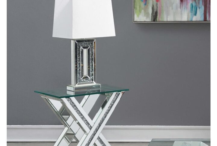 This eye-catching modern glam end table presents a striking X-shaped pedestal base design that adds interest to your living room. Across the dramatically flared X-shaped base is a collection of reflective mirror trim and tile